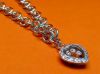 Image de « Ludique », bracelet en argent sterling, chaîne maille jaseron avec breloque en forme de cœur entouré de zircones cubiques et contenant des zircones flottantes