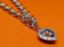 Picture of “Playful” bracelet in sterling silver, rolo link chain with heart charm outlined with cubic zirconia and containing floating zirconia