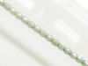 Picture of 3x3 mm, Czech faceted round beads, chalk white, opaque, light celadon green luster