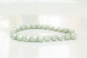 Picture of 4x4 mm, Czech faceted round beads, chalk white, opaque, light celadon green luster